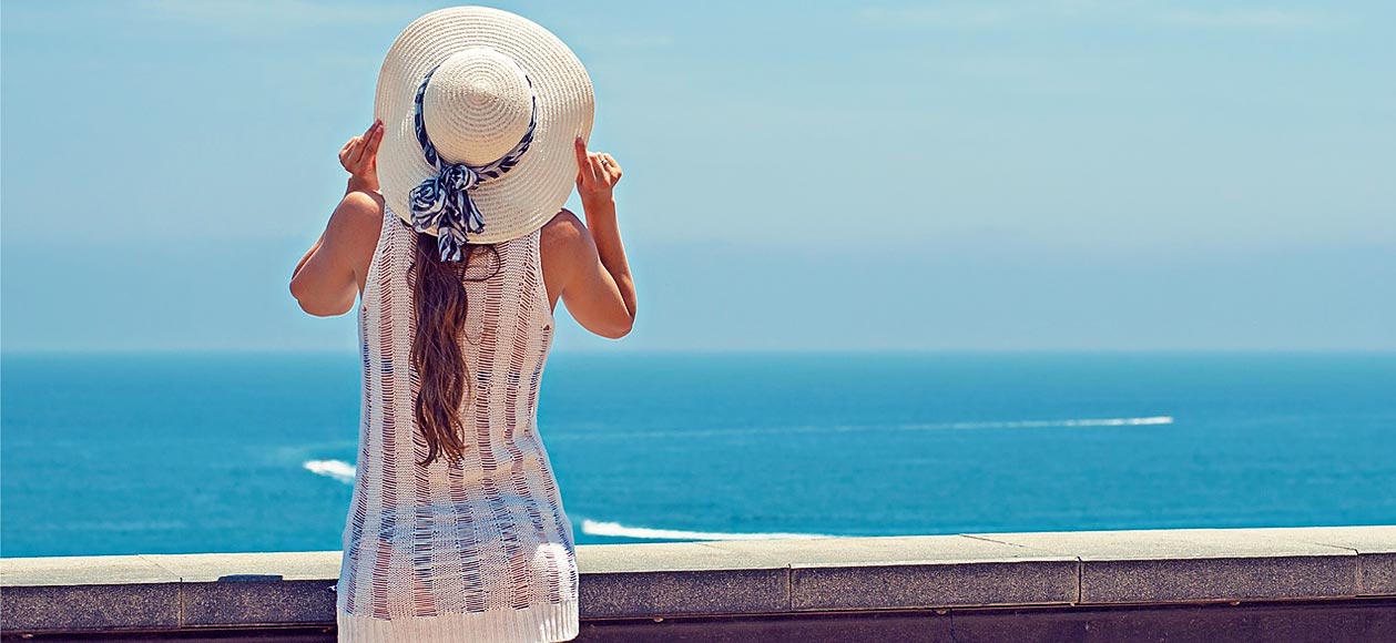 Woman enjoying summer by the beach